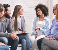 A group therapy session in an alcohol rehab program, featuring participants engaged in discussion