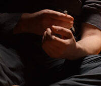 Close-up of hands preparing heroin for injection, highlighting the dangers and urgency of addressing heroin addiction