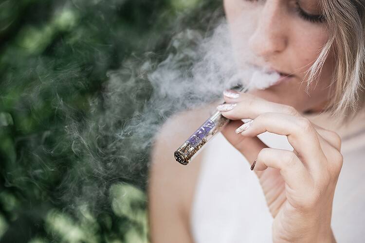 Woman smoking cocaine, illustrating the harmful effects and risks of cocaine abuse