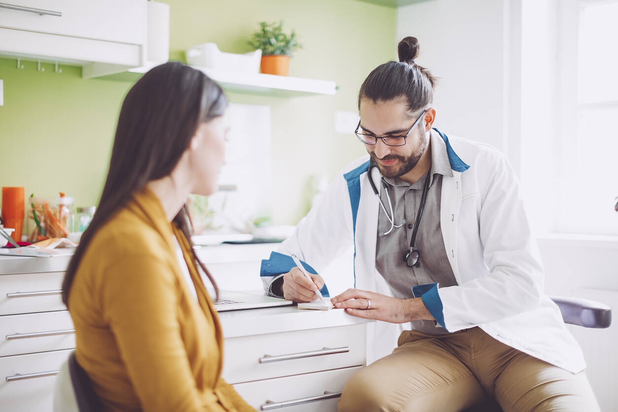 Doctor discussing opiate addiction treatment options with a patient in a medical office, emphasizing personalized care and professional guidance