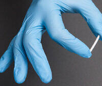 Medical professional's hand in blue glove holding a naltrexone implant for addiction treatment