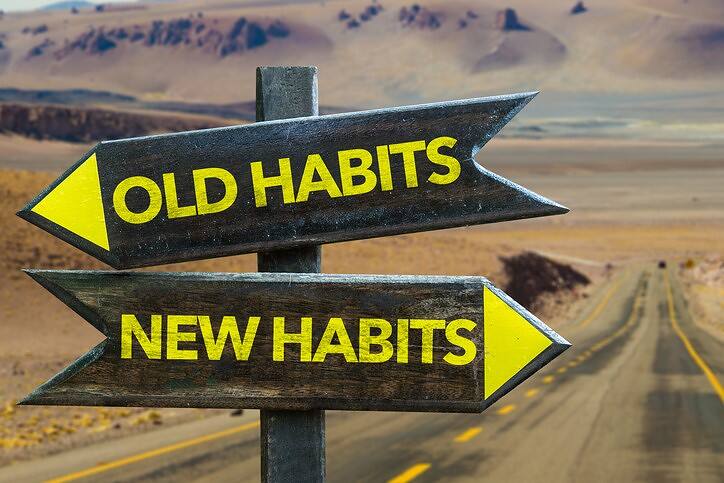 Road sign showing 'Old Habits' pointing left and 'New Habits' pointing right, with a desert highway in the background, symbolizing the journey from cross-addiction to recovery