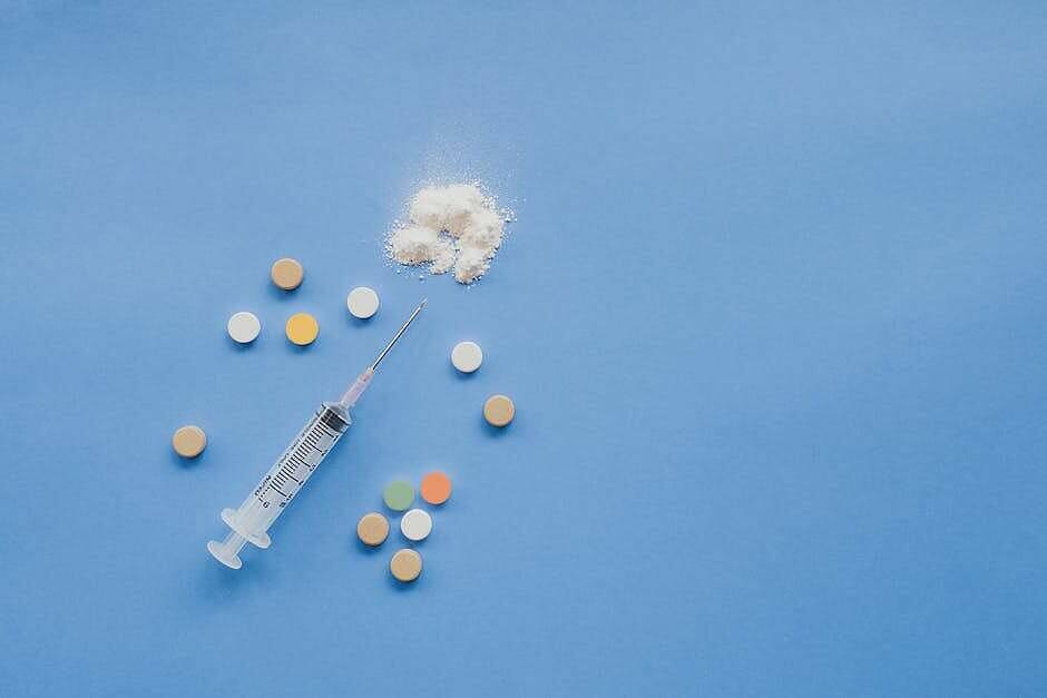 Various morphine forms including pills, white powder, and a syringe displayed on a light blue surface