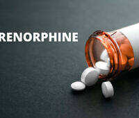 Orange prescription bottle spilling white Buprenorphine tablets on dark surface, with 'BUPRENORPHINE' text overlay