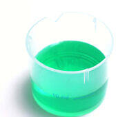 Bright green methadone liquid in a clear 10ml measuring cup, used for addiction treatment