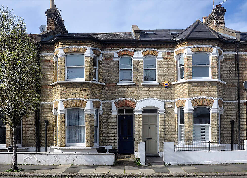 Victorian-style London townhouses with bay windows and brick facades, representing potential residential aftercare facilities in urban settings