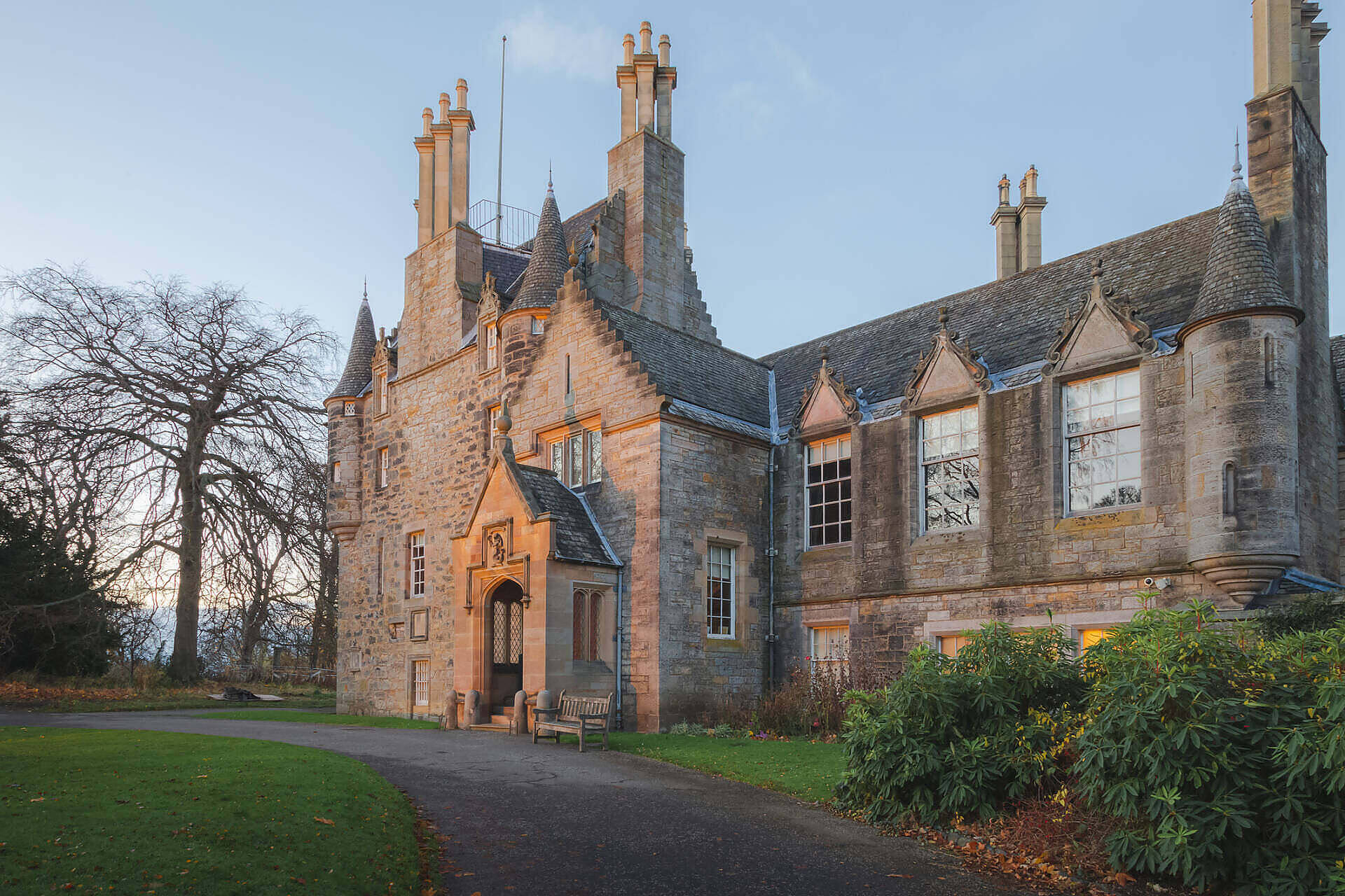 Historic Scottish manor house with stone facade and turrets, serving as a luxurious rehab facility in Glasgow