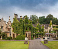 Elegant stone manor house with ivy-covered walls, serving as an alcohol rehab facility in Nottinghamshire, surrounded by manicured lawns and gardens