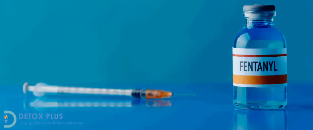 Vial of fentanyl with a syringe on a blue table