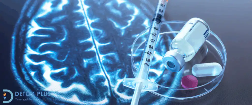 Drug vial pills and syringe on top of a brain CT scan