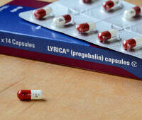 Box of Lyrica (pregabalin) 75mg capsules with red and white pills on blister pack