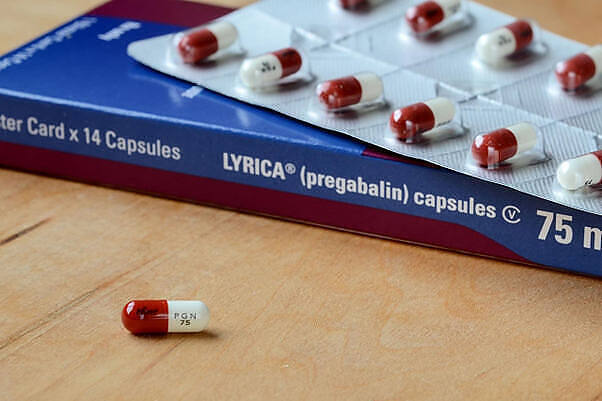 Box of Lyrica (pregabalin) 75mg capsules with red and white pills on blister pack