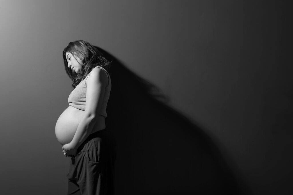 black and white photograph of a pregnant woman