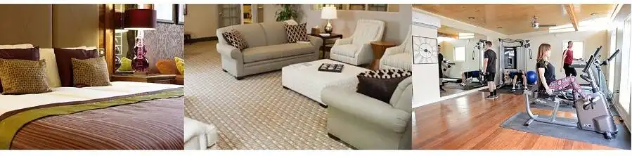 Collage of luxury rehab facilities showing bedroom, lounge area, and fitness center with exercise equipment|Serene landscape of Oxfordshire with a calm lake, lush green trees, and a distant building, symbolizing a peaceful environment for rehabilitation and healing|Friendly male doctor in white coat shaking hands with a patient in an office setting, holding a blue clipboard, symbolizing trust and care in medical treatment|Young woman with short brown hair smiling during a therapy session, engaged in conversation with a counselor in a bright, comfortable setting|Collage of high-end rehab facility amenities: plush bedroom, spacious living room with comfortable furniture, and modern gym with exercise equipment and people working out