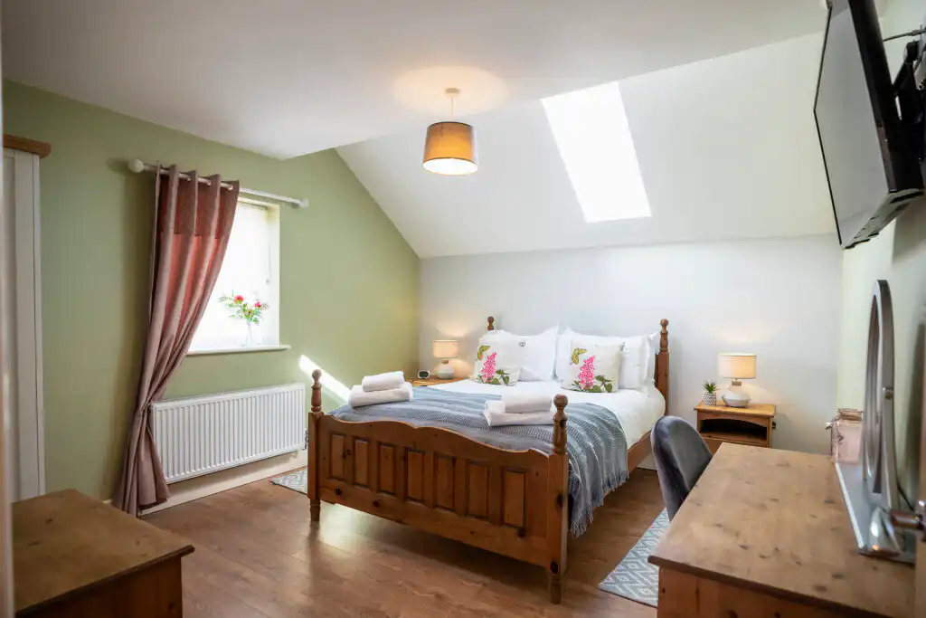 a bedroom with a bed and a desk